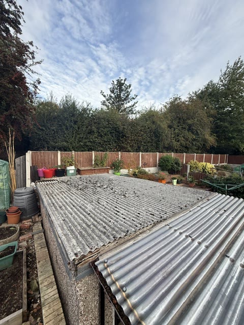 Mossed corrugated cement sheet roof on a garage