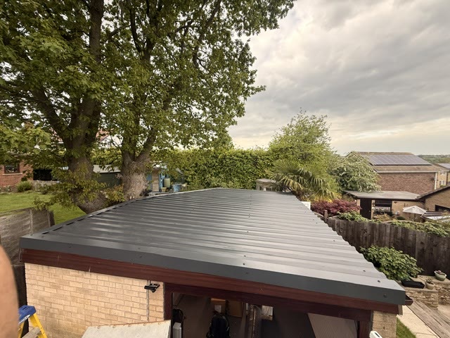 The same garage re-roofed in anthracite box-profile steel sheet
