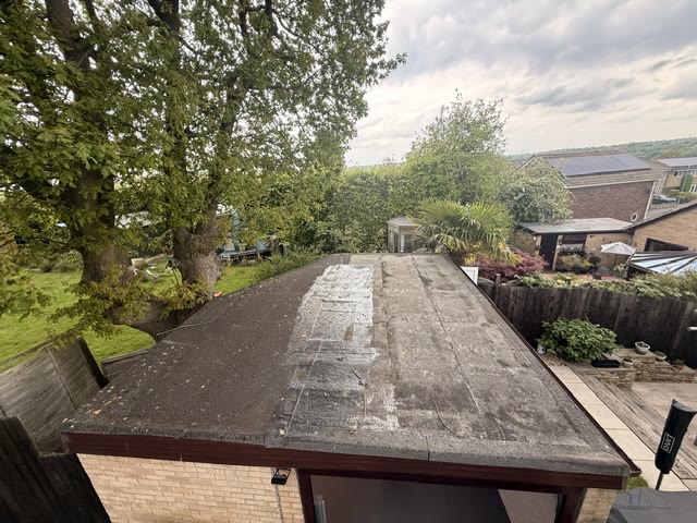 Worn and patched felt garage roof