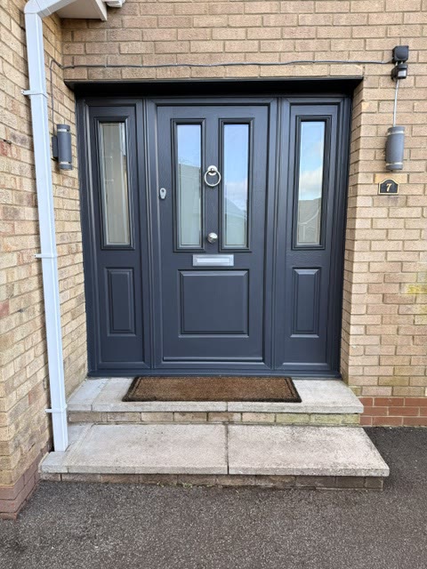 Anthracite composite front door with glazed side panels and a chrome knocker