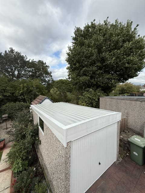 New white box-profile roof and matching cladding on the same garage
