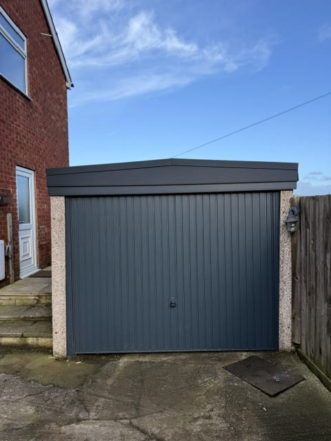 Anthracite up-and-over garage door with a new apex roof and fascia